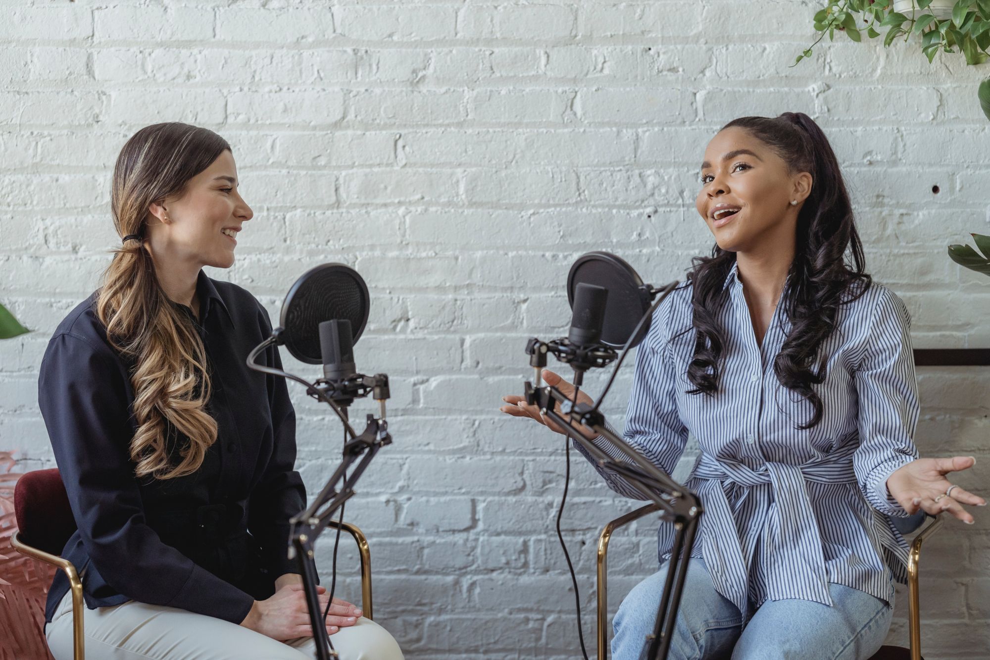 two women speaking on a podcast