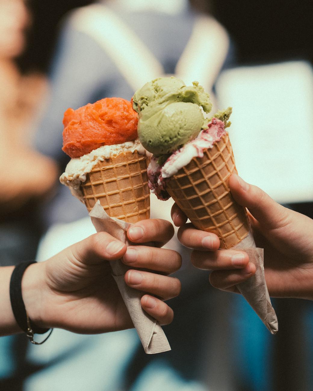 hands holding ice creams